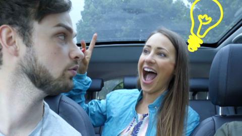 A lady and a man in a car looking surprised.
