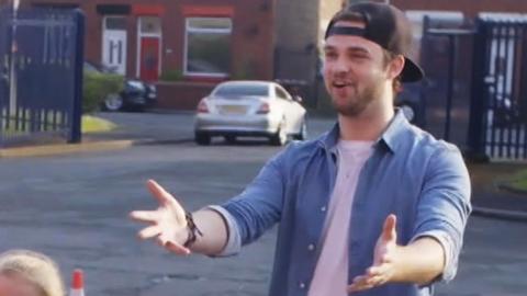 Ali-A with his arms outstretched.