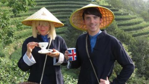 Two people in a tea field.