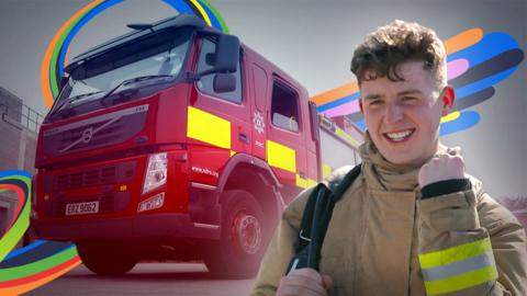 Adam standing in front of a fire truck.