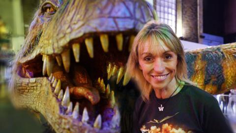 Michaela Strachan with a life-sized puppet of a baby T-rex dinosaur.