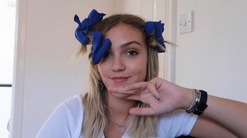 Molly AKA Beauty Spectrum with homemade curlers in her hair.
