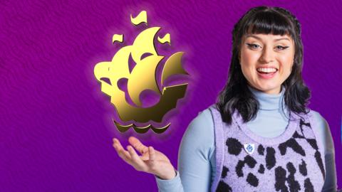 Blue Peter presenter Abby Cook holding up a Gold blue peter badge.