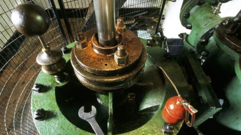 A close-up of part of the pump mechanism, spanner and oilcan in the engine house
