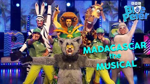 The cast of Madagascar the Musical dressed as zoo animals including lions, giraffes, hippos and lemurs, they are in a powerful end of performance pose.