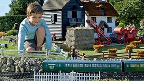A boy playing with a model farm
