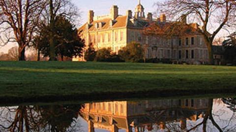 The outside of Belton House on an autumn day.