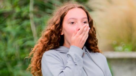 A girl looking shocked.