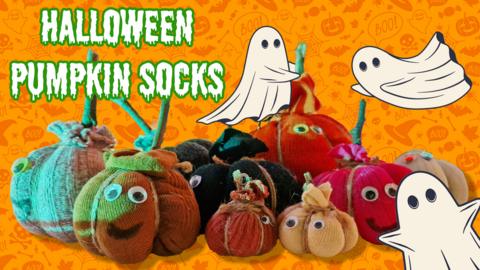 A collection of pumpkins made out of stuffed socks, three cartoon ghosts float around them.