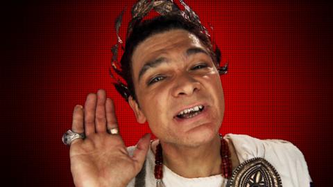 A roman with his hand to his ear.