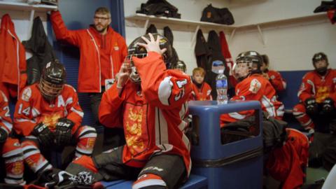 A room filled with ice hockey players.