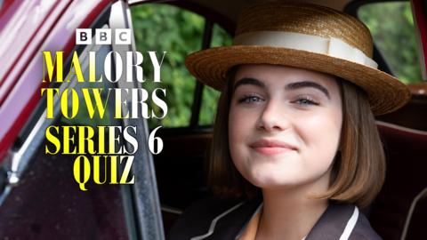 Darrell from Malory Towers, she is sat in a car, wearing a hat and smiling towards the camera.