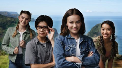 Close up image of characters from Mystic, two girls and a boy standing on a cliffside covered in greenery.