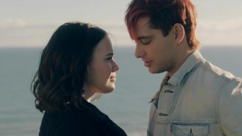 Issie and a mystery man from Mystic smiling.