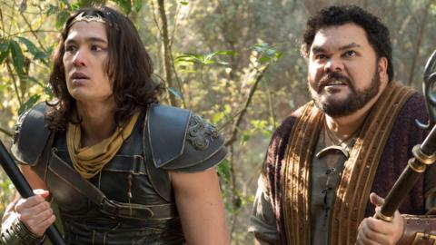 Two men wearing armour in a forest looking alert while they hold weapons, Monkey and Pigsy.