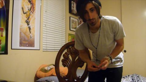 A man stood in front of a chair.