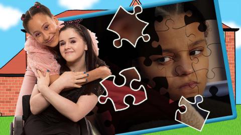 Two girls hugging next to a picture of a jigsaw half completed.