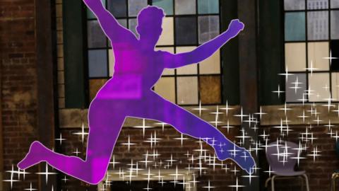 A silhouette of a dancer jumping in the air.