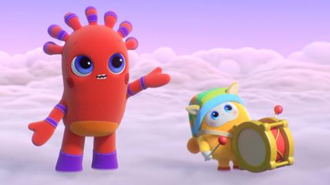 MeMo, looking into the distance with hand outstretch, trying to stop BaBa from playing their big noisy drum.