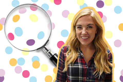 Maddie is smiling to camera, a magnify glass is behidn her over a multi coloured polka dot background.