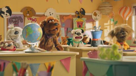 Image of Dodge's Pup School characters sat in a colourful classroom.