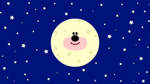 Dark blue sky with stars and a large moon with a face.