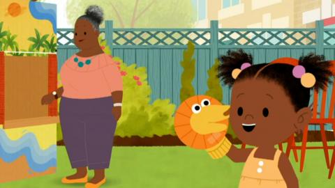 JoJo is holding a sock puppet.