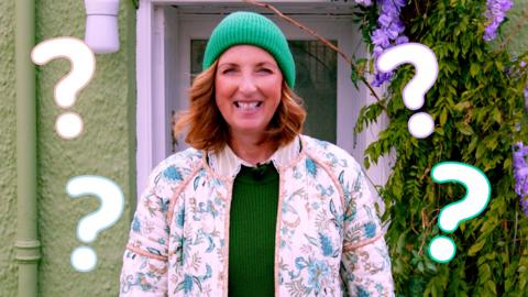 Image of Miss Hoolie in front of a green house surrounded by question marks.