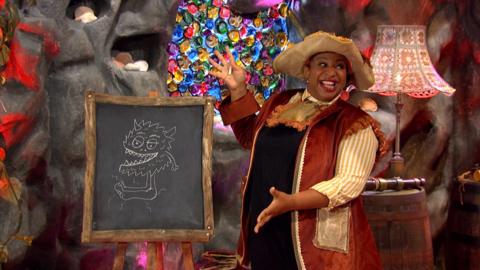 Captain HeyHo i showcasing a chalkboard with a monster drawn on it