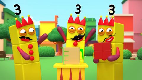 Three Numberblock Threes wearing crowns and moustaches. One holds four red cups in a block, one stands before a podium bearing a full jug, and one holds their hands up, looking excited.