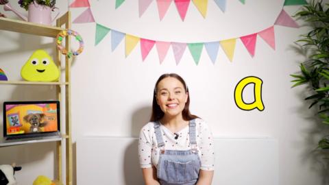 Evie looks at the letter A as she learns how to pronounce it.