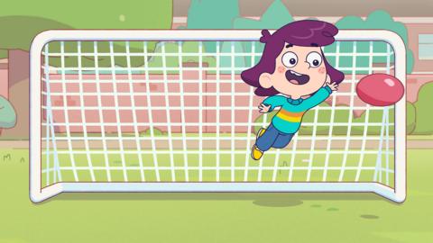 Image of a young girl jumping in the air to save a football going into the top corner of a goal.
