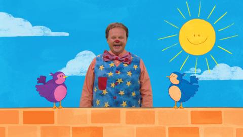 Mr Tumble and two little birds on a wall