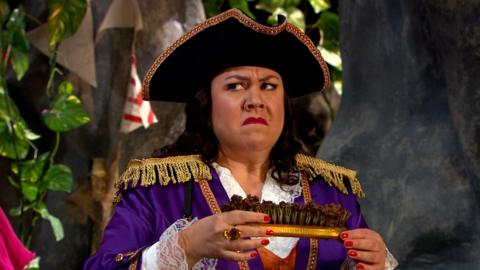 Captain Captain is looking suspiciously whilst holding a muddy brush.