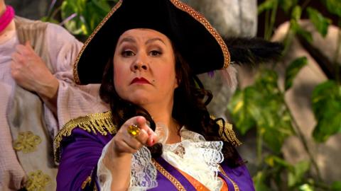 Captain Captain is pointing at the camera with a stern face.