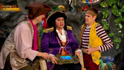 Captain Captain is looking angry, whilst holding a gaming console in her hands. Sandy and Seaweed look worried.