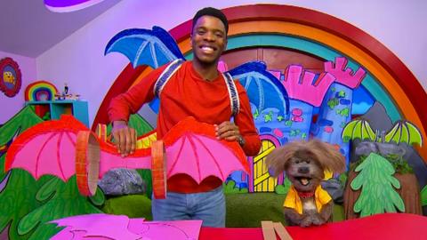 Image of CBeebies House presenters posing in the studio with Zog wings.