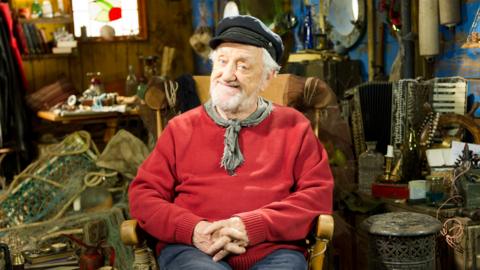 Jack from Old Jack\u2019s Boat smiling and sitting in his armchair.