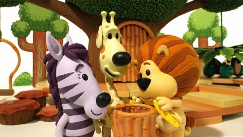 Raa Raa the Noisy Lion putting a banana skin into a bin, with Zebby and Topsy.