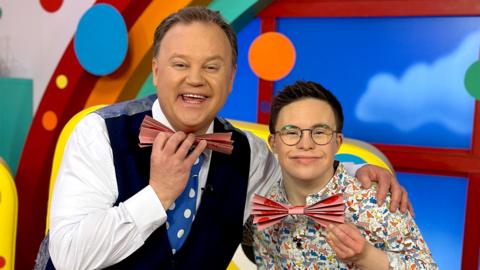 Justin and George make a Mr Tumble bow tie