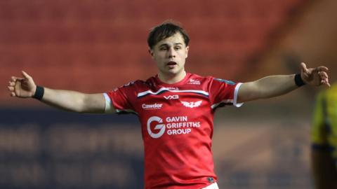 Carwyn Leggatt-Jones holds his arms out wide while playing for Scarlets