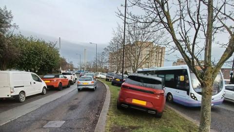 Cars parked on verge