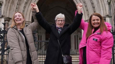 Former subpostmistress Kathleen Crane outside the Royal Courts of Justice in London, with her daughters, Lucy (left) and Katy (right)