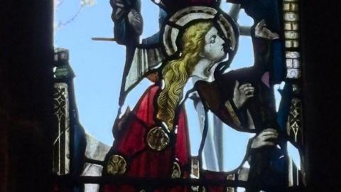 Close-up of a damaged stained glass window.