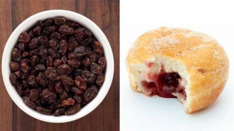 A bowl of raisins and a jam doughnut