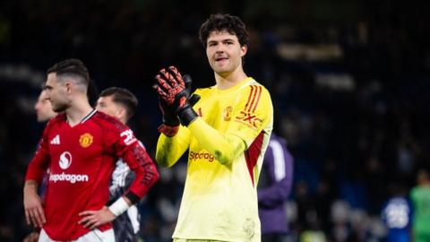 Manchester United goalkeeper Senne Lammens applauds the visiting fans after the 1-0 win at Chelsea