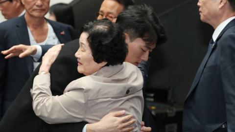 Chun Woo-won (L), a grandson of the late former South Korean President Chun Doo-hwan, comforts a bereaved family member of a victim of the crackdown on a pro-democracy uprising in 1980 in the city of Gwangju, South Korea, 31 March 2023, as he offers an apology in lieu of his grandfather. The 27-year-old has referred to his grandfather as 'a slaughterer' due to the military's brutal suppression of the Gwangju uprising after he seized power through a coup in 1979.