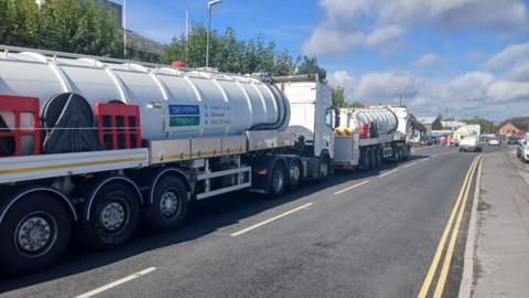 Image of two large water tankers on a road with Severn Trent branding on the side.