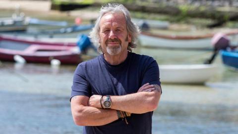 Rob Trewhella standing in front of some boats