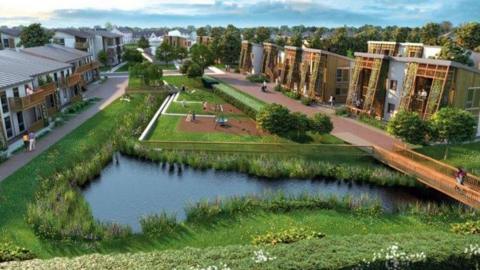 A visualisation used in the design code planning guidance for the forthcoming Burtree Garden Village. It shows a green space with a small pond in the centre, surrounded by two storey white houses with brown balconies. 